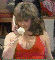 Wendy Richard as Shirley in a low-cut red dress